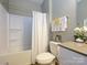 Bathroom featuring a tub with shower, tile surround, and modern vanity with ample storage at 54 Woodsdale Se Pl, Concord, NC 28025