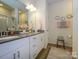 Modern bathroom featuring a double sink vanity, white cabinets, and a glass-enclosed shower at 54 Woodsdale Se Pl, Concord, NC 28025
