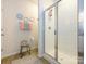 Bright bathroom features a tiled shower with a glass door and a decorative stool at 54 Woodsdale Se Pl, Concord, NC 28025