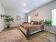 Bright bedroom with a comfortable bed, natural light, and hardwood floors for a relaxing atmosphere at 54 Woodsdale Se Pl, Concord, NC 28025