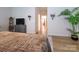 Relaxing bedroom showcasing a luxurious bed, hardwood floors, and a TV area for ultimate comfort at 54 Woodsdale Se Pl, Concord, NC 28025
