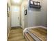 Welcoming hallway with hardwood floors, a decorative mirror, and easy access to other rooms at 54 Woodsdale Se Pl, Concord, NC 28025