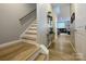 Inviting hallway with hardwood floors leads to living areas and staircase, showcasing home's layout at 54 Woodsdale Se Pl, Concord, NC 28025