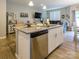 Open-concept kitchen featuring an island with a sink, stainless steel appliances, and seamless living area at 54 Woodsdale Se Pl, Concord, NC 28025