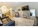 Comfortable living room showcasing a leather sofa, television, and stylish decor throughout an open-concept layout at 54 Woodsdale Se Pl, Concord, NC 28025