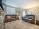Inviting living room showcasing leather sofas, large windows, and access to a patio for relaxation and enjoyment at 54 Woodsdale Se Pl, Concord, NC 28025