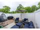 Cozy outdoor patio with comfortable seating, an umbrella, and a privacy fence is the perfect retreat at 54 Woodsdale Se Pl, Concord, NC 28025
