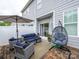 This outdoor patio features stylish seating and decor, along with a view of the home's exterior at 54 Woodsdale Se Pl, Concord, NC 28025