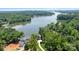 Aerial view of a stunning waterfront property with mature trees at 5930 Midsomer Rd, Charlotte, NC 28214