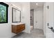 Bathroom features a floating vanity with hardwood and modern tiling in the shower and floors at 5930 Midsomer Rd, Charlotte, NC 28214