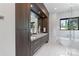 The bathroom features a double sink vanity with dark wood cabinets and a modern free standing tub at 5930 Midsomer Rd, Charlotte, NC 28214