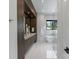 Modern bathroom featuring a soaking tub, marble tile, and a glass-enclosed shower at 5930 Midsomer Rd, Charlotte, NC 28214