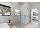Bright bathroom features a glass shower with a rainfall shower head and a view from the window at 5930 Midsomer Rd, Charlotte, NC 28214