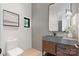 Contemporary powder room featuring a vessel sink, decorative mirror, and a modern aesthetic at 5930 Midsomer Rd, Charlotte, NC 28214