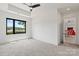 Modern bedroom showcasing a scenic lake view from a large window and an adjacent dining and entertainment area at 5930 Midsomer Rd, Charlotte, NC 28214