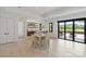 Open dining space with bar area access and sliding doors to outdoor space at 5930 Midsomer Rd, Charlotte, NC 28214