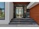 Welcoming entryway with stone steps, glass doors, and elegant design elements at 5930 Midsomer Rd, Charlotte, NC 28214