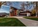 Stunning lakefront home with modern design, stone accents, and a spacious driveway at 5930 Midsomer Rd, Charlotte, NC 28214