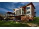 Stunning modern home with an expansive deck, lake views, and lush landscaping at 5930 Midsomer Rd, Charlotte, NC 28214