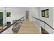 Hallway with glass railing overlooking the living and dining room at 5930 Midsomer Rd, Charlotte, NC 28214