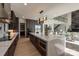 Modern kitchen with an expansive island, stainless appliances, and bright lighting at 5930 Midsomer Rd, Charlotte, NC 28214
