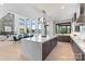A modern kitchen featuring a large island, stainless steel appliances, and an open floor plan with water views at 5930 Midsomer Rd, Charlotte, NC 28214