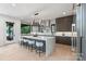 Modern kitchen with a large island, stainless steel appliances, custom cabinetry, and sleek countertops at 5930 Midsomer Rd, Charlotte, NC 28214