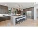 Contemporary kitchen features a large central island with seating, stainless steel appliances, and stylish finishes at 5930 Midsomer Rd, Charlotte, NC 28214