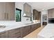 Sleek kitchen featuring modern appliances, custom cabinets, and elegant countertops with a view to the outdoors at 5930 Midsomer Rd, Charlotte, NC 28214