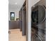 A modern laundry room with stacked washer/dryer and custom storage at 5930 Midsomer Rd, Charlotte, NC 28214