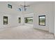 Spacious living room with soaring ceilings and multiple windows providing plenty of natural light at 5930 Midsomer Rd, Charlotte, NC 28214