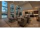 Bright living room with soaring windows, lake views, and open floor plan at 5930 Midsomer Rd, Charlotte, NC 28214