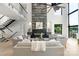 Modern living space featuring a soaring stone fireplace, contemporary furnishings, and large windows with scenic water views at 5930 Midsomer Rd, Charlotte, NC 28214