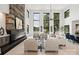 Open living room with fireplace and floor-to-ceiling windows overlooking the lake at 5930 Midsomer Rd, Charlotte, NC 28214