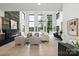 Expansive living room with soaring ceilings, a stone fireplace, and floor-to-ceiling windows overlooking the lake at 5930 Midsomer Rd, Charlotte, NC 28214