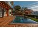 Inviting outdoor pool area with modern deck, lounge space, and lush greenery at 5930 Midsomer Rd, Charlotte, NC 28214