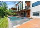 Modern home featuring a luxurious pool, spa, and a spacious outdoor deck for relaxation and entertainment at 5930 Midsomer Rd, Charlotte, NC 28214