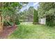 Serene backyard featuring a hammock, statue, shed, and well-maintained lawn at 6057 Erie View Ct, Denver, NC 28037