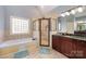 Bathroom features a glass enclosed shower and garden tub at 6057 Erie View Ct, Denver, NC 28037