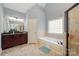 Bathroom with walk-in shower, a bathtub, and neutral tile work at 6057 Erie View Ct, Denver, NC 28037