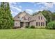 Charming brick home featuring a manicured lawn, lush landscaping, and a classic architectural design at 6057 Erie View Ct, Denver, NC 28037