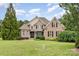 Charming brick home featuring a manicured lawn, lush landscaping, and a classic architectural design at 6057 Erie View Ct, Denver, NC 28037