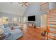 Spacious living room featuring vaulted ceilings, hardwood floors, and a gray sofa at 6057 Erie View Ct, Denver, NC 28037