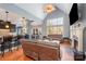 Open floor plan with a living room featuring a fireplace, and views into kitchen and dining at 6057 Erie View Ct, Denver, NC 28037