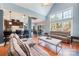 Open floor plan with a living room, view of the kitchen and fireplace, and hardwood flooring at 6057 Erie View Ct, Denver, NC 28037