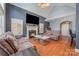 Cozy living room with fireplace, vaulted ceiling, and hardwood floors at 6057 Erie View Ct, Denver, NC 28037