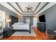 Main bedroom with hardwood floors, decorative ceiling, and ensuite bathroom access at 6057 Erie View Ct, Denver, NC 28037