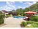 Inviting backyard pool with a slide, lounge chairs, and lush greenery, perfect for relaxation at 6057 Erie View Ct, Denver, NC 28037