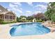 Backyard inground pool featuring a waterfall feature, slide, lights, and patio furniture at 6057 Erie View Ct, Denver, NC 28037