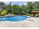Stunning backyard pool featuring a beautiful rock waterfall and mature landscaping at 6057 Erie View Ct, Denver, NC 28037